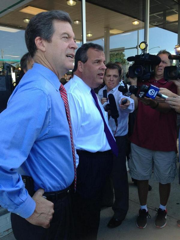 Sam Brownback and Chris Christie talked to reporters outside Oklahoma Joe's before picking up a to-go order. Photo via Brownback for Governor Twitter account.