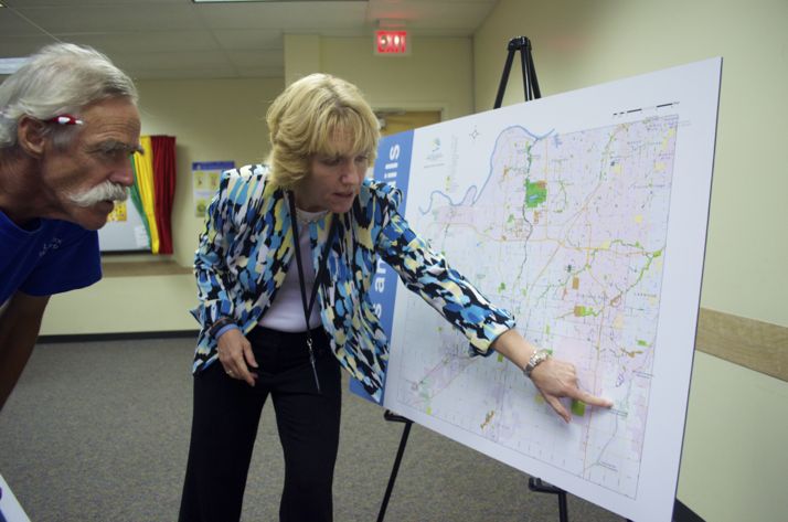 Johnson County Parks Director Jill Geller answers questions from Richard Voss at an open house at Antioch Library Tuesday night designed to get input about the future of the county parks.